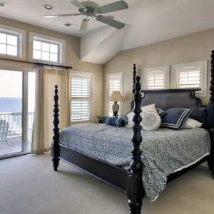 Sandmark custom remodel. Photograph of bed in carpeted bedroom